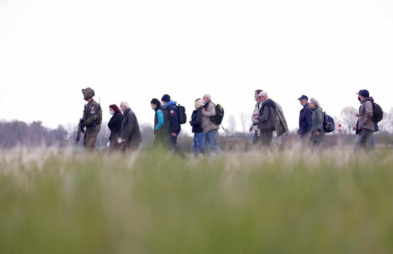 A soldier leads people during the 