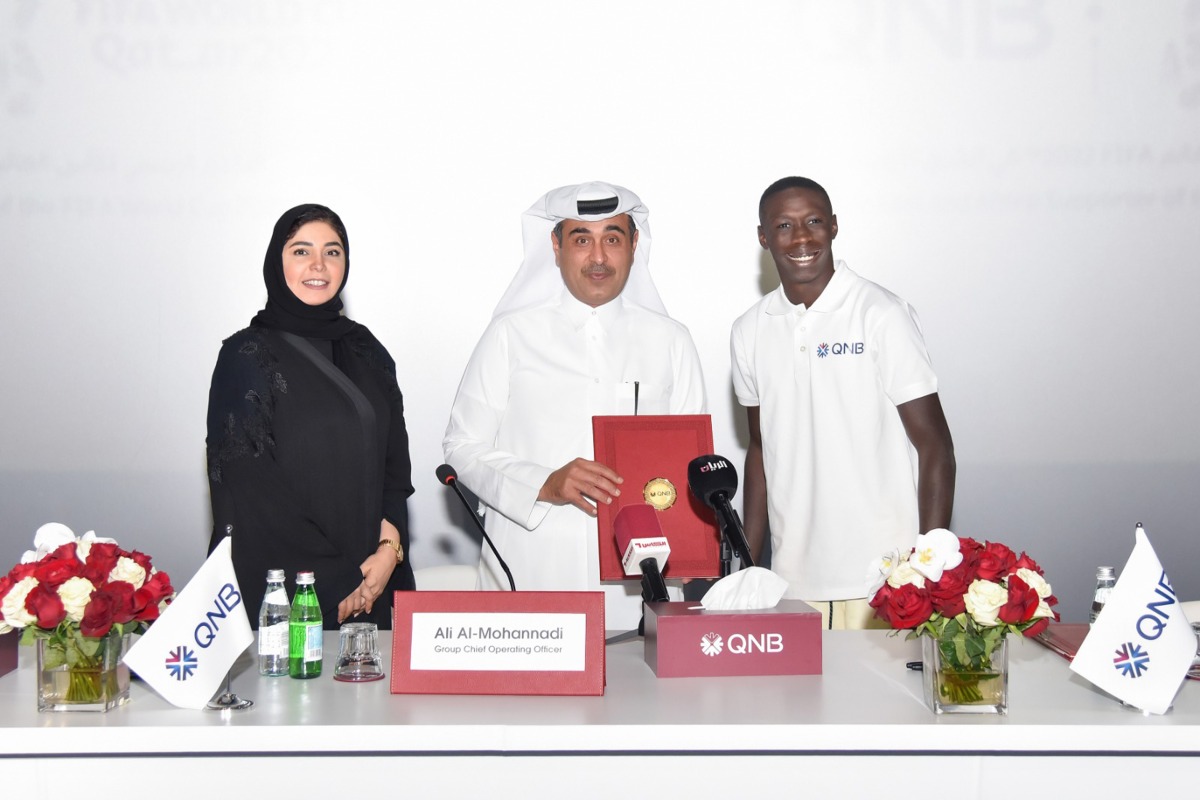 Internet sensation Khabane ‘Khaby’ Lame (first right) with Ali Rashid Al Mohannadi (centre), QNB Group’s Executive General Manager and Group Chief Operating Officer, and Heba Ali Al Tamimi, General Manager of QNB Group Communications, during the signing ceremony and TVC screening at the Mall of Qatar, yesterday. 
