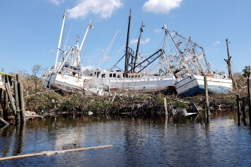 Stranded shrimp boats are seen in the Matanzas Pass after Hurricane Ian caused widespread destruction in Fort Myers Beach, Florida, on October 1, 2022. REUTERS/Marco Bello