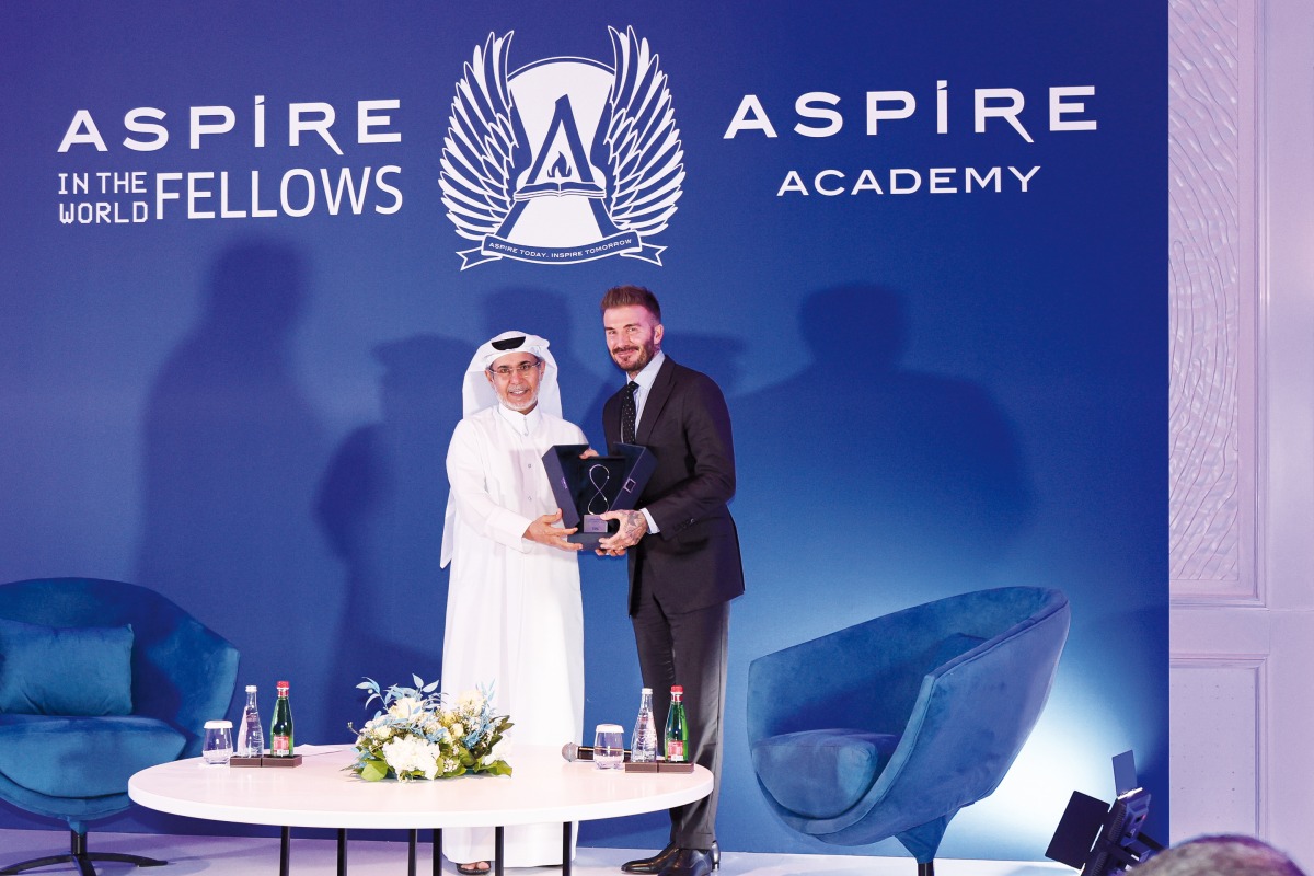 Deputy Director General of Aspire Academy Ali Salem Afifa presents a memento to English football legend David Beckham.