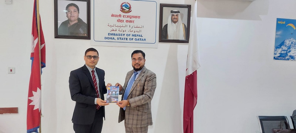 Prof Mohammed Ramzan Ali Miya presenting a copy of Maile Dekheko Qatar to Laxuman Khanal, Deputy Chief of Mission of the Nepal Embassy in Qatar.