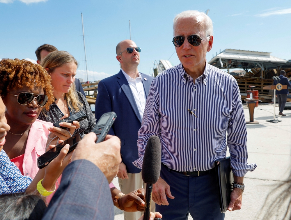 US President Joe Biden speaks to media as he tours areas damaged by Hurricane Ian during a visit to Florida, in Fort Myers Beach, Florida, US, on October 5, 2022. REUTERS/Evelyn Hockstein/File Photo