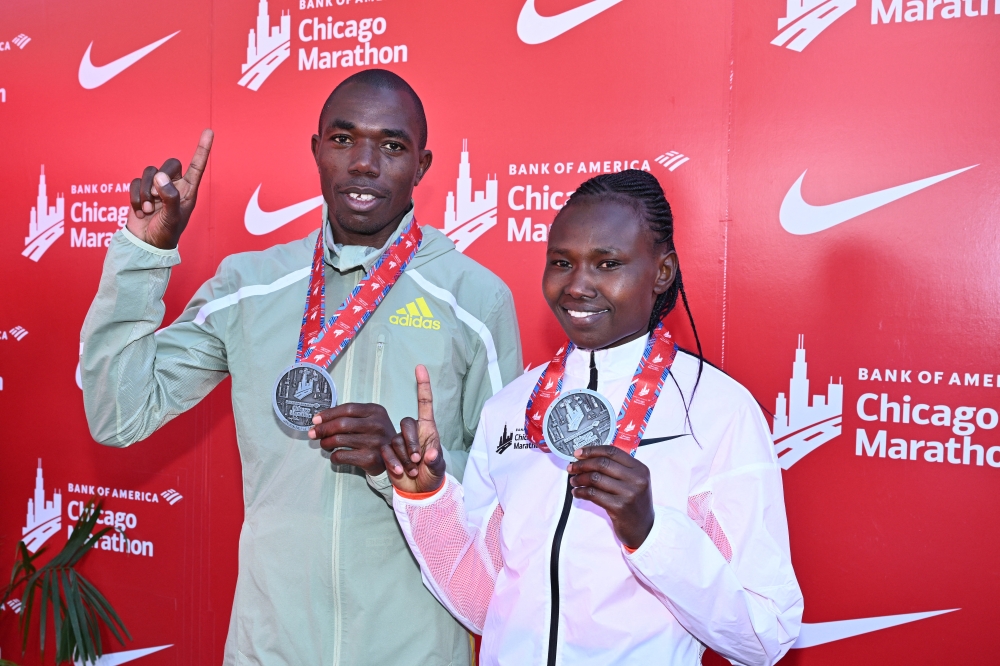 Benson Kipruto (left) and Ruth Chepngetich, both from Kenya, pose with their medals after they won the 2022 Chicago Marathon in Chicago, Illinois, on October 9, 2022. Mandatory Credit: Jamie Sabau-USA TODAY Sports