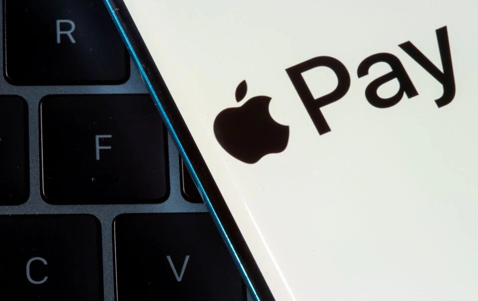 A smartphone with the Apple Pay logo is placed on a laptop in this illustration taken on July 14, 2021. File Photo / Reuters