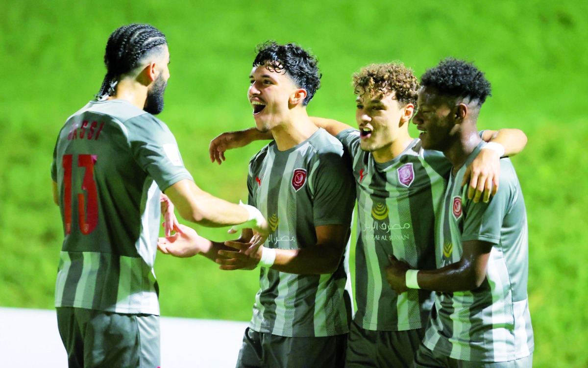 Al Duhail's Suhaib Gannan celebrates with team-mates after scoring their second goal.