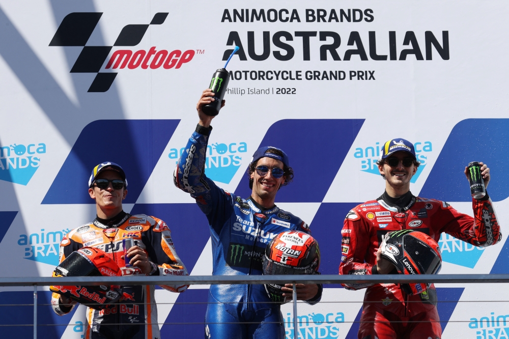 Team Suzuki Ecstar's Alex Rins celebrates on the podium with second placed Repsol Honda Team's Marc Marquez and third placed Ducati Lenovo's Francesco Bagnaia after winning the Australian Grand Prix at the Phillip Island Grand Prix Circuit, Phillip Island, Australia, on October 16, 2022.   REUTERS/Loren Elliott