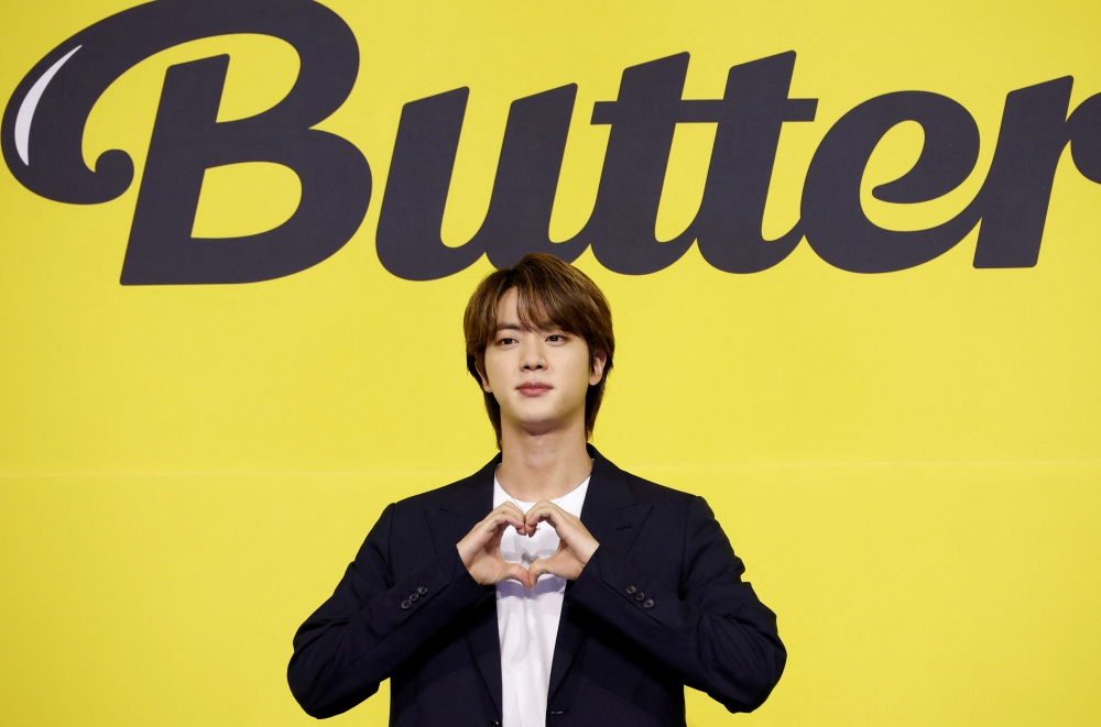 K-pop boy band BTS member Jin poses for photographs during a photo opportunity promoting their new single 'Butter' in Seoul, South Korea, May 21, 2021. REUTERS/Kim Hong-Ji/File Photo