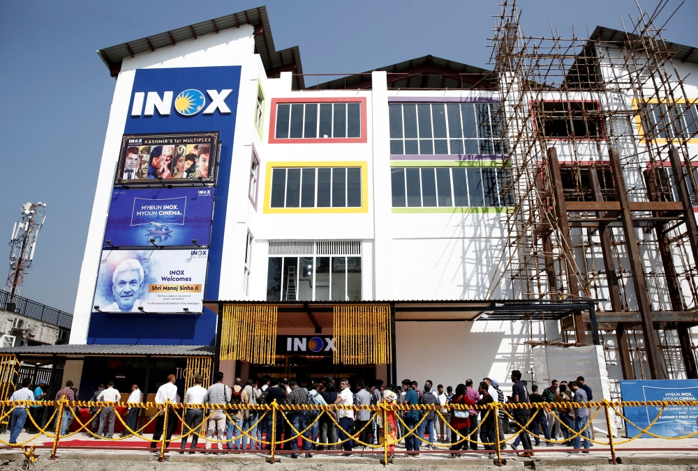 Members of media and Jammu and Kashmir government officials wait to enter a multi-screen cinema hall run by India's leading multiplex chain INOX before its inauguration in Srinagar, September 20, 2022. (REUTERS/Danish Ismail)