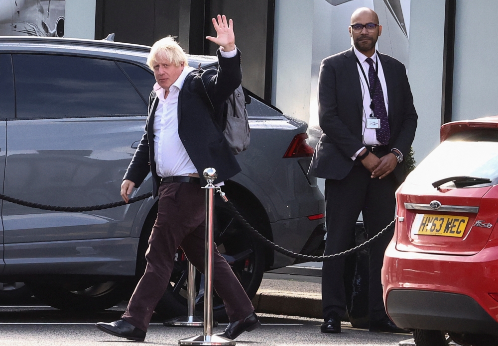 Former British Prime Minister Boris Johnson gestures, at Gatwick Airport, near London, Britain October 22, 2022. REUTERS/Henry Nicholls