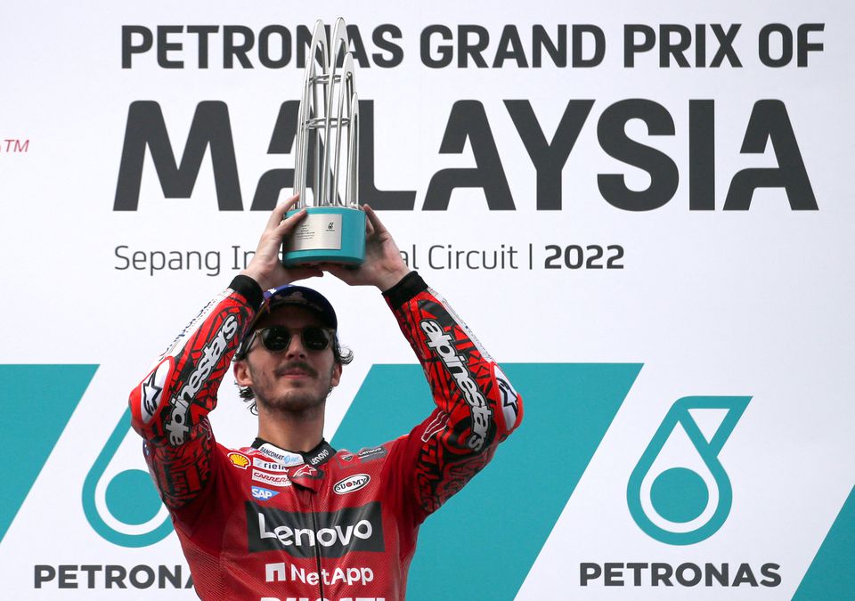 October 23, 2022 Ducati Lenovo's Francesco Bagnaia celebrates on the podium with trophy after winning the Malaysian Grand Prix REUTERS/Hasnoor Hussain


