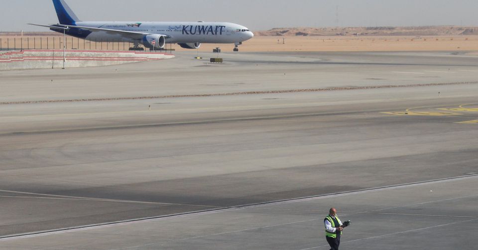 A Kuwait Airways plane parked at Cairo International Airport is pictured through the window of an airplane on a flight between Cairo and Doha, Egypt, on November 27, 2021. File Photo / Reuters
