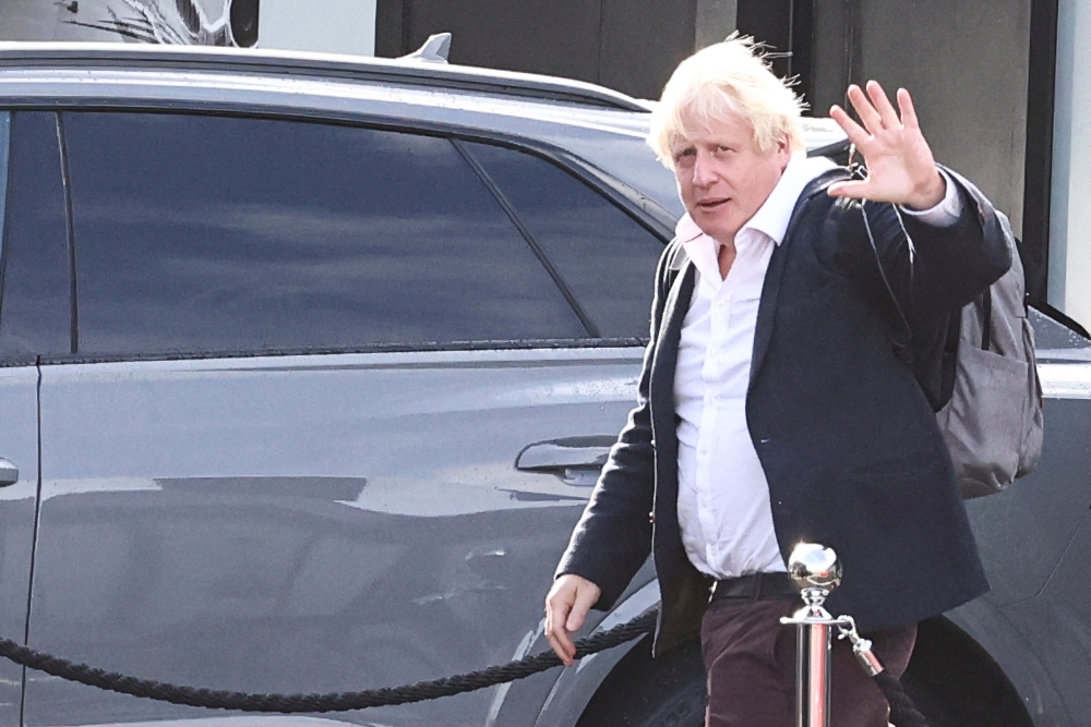 Former British Prime Minister Boris Johnson walks, at Gatwick Airport, near London, Britain, on October 22, 2022. REUTERS/Henry Nicholls