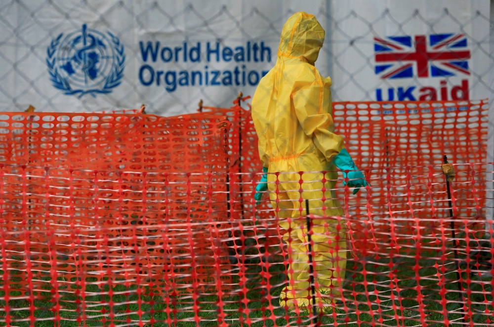 A person dressed in Ebola protective apparel is seen inside an Ebola care facility at the Bwera general hospital near the border with the Democratic Republic of Congo in Bwera, Uganda, June 14, 2019. REUTERS/James Akena?/File Photo