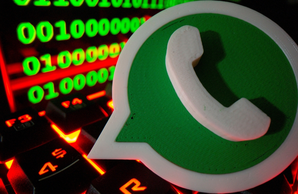  A 3D printed Whatsapp logo is pictured on a keyboard in front of binary code in this illustration taken September 24, 2021. Reuters/Dado Ruvic/Illustration/File Photo