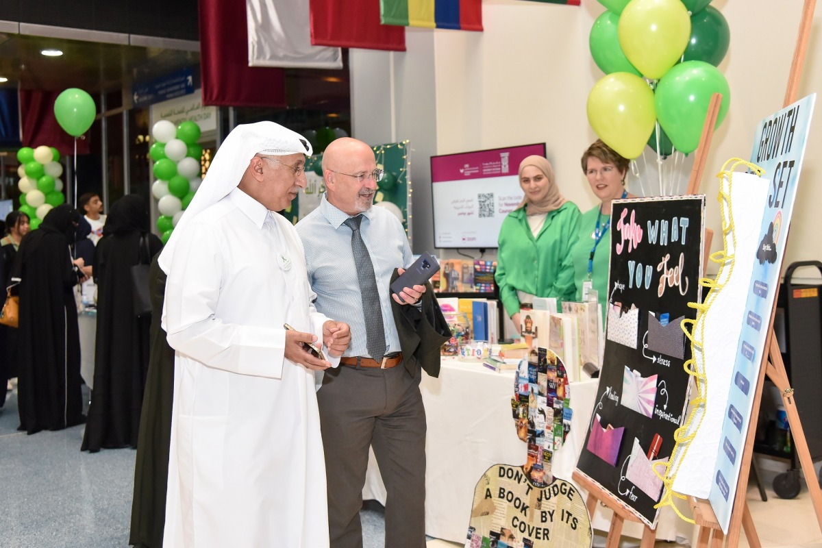 Officials at a stand during UDST's World Mental Health Day event.