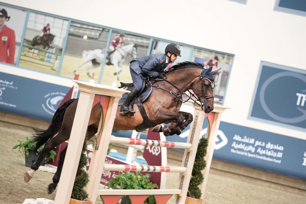 Faleh Suwead Al Ajami guides Ambre De Beaufour over a fence.