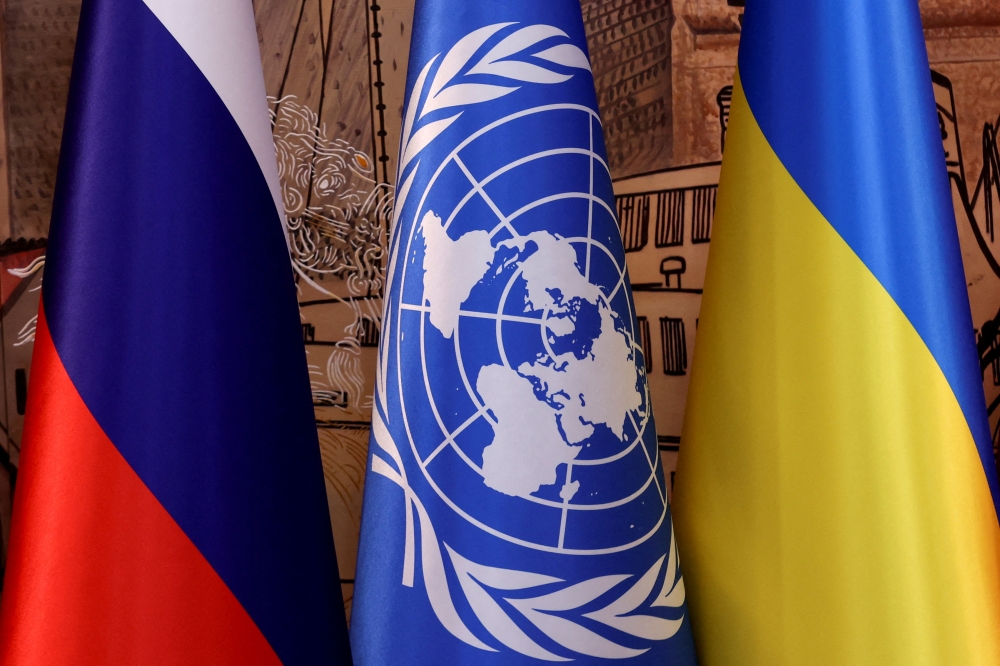 Flags of Russia, the United Nations and Ukraine are seen on the day of a signing ceremony in Istanbul, Turkey July 22, 2022. (REUTERS/Umit Bektas)