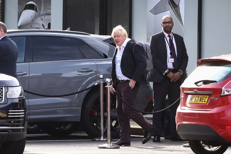 Former British Prime Minister Boris Johnson walks, at Gatwick Airport, near London, Britain October 22, 2022. REUTERS/Henry Nicholls