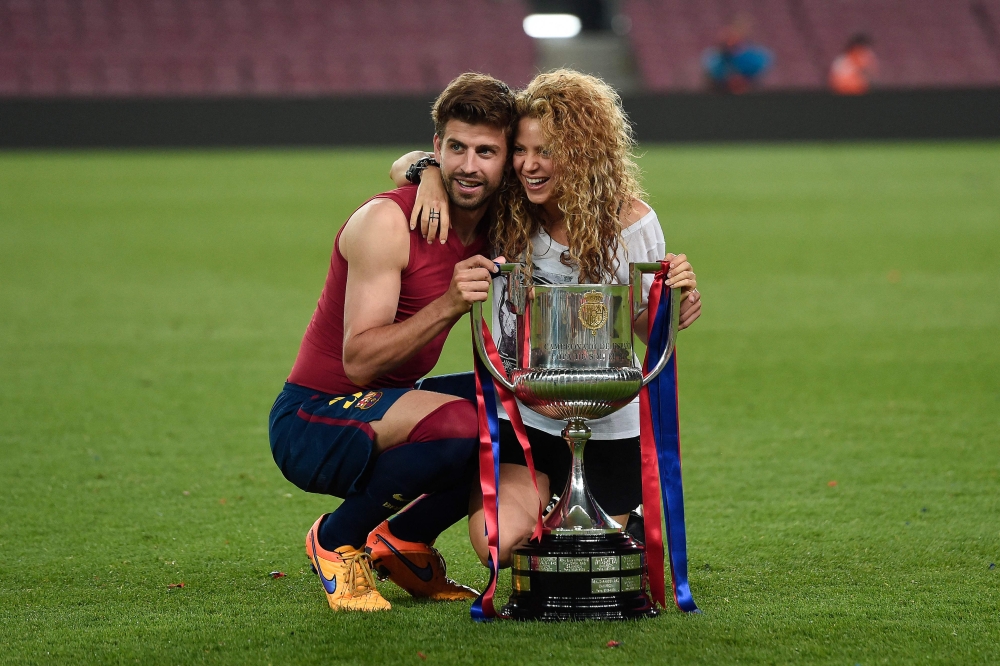 In this file photo taken on May 31, 2015, Barcelona's defender Gerard Pique and his wife Colombian singer Shakira pose with the trophy at the end of the Spanish Copa del Rey (King's Cup) final football match at the Camp Nou stadium in Barcelona. (Josep LAGO / AFP)