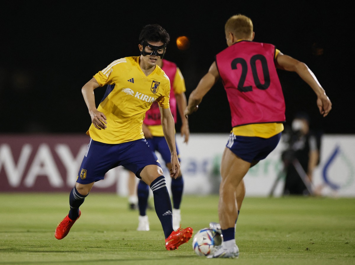 Japan’s Shogo Taniguchi with a team-mate during a training session at Al Sadd Sports Club, yesterday. REUTERS