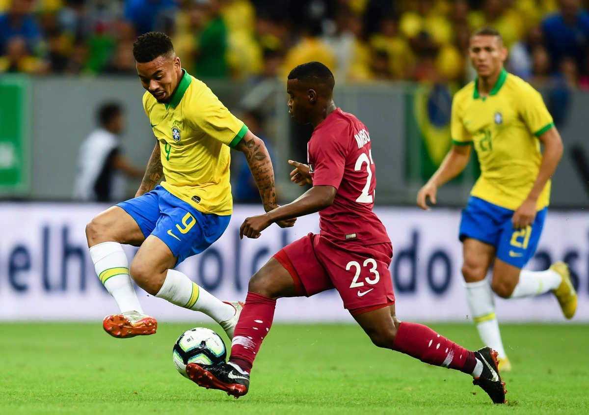 Qatar’s Assim Madebo and Brazil’s Gabriel Jesus (left) vie for the ball during a friendly match in Brasilia, in this June 5, 2019 file photo. AFP