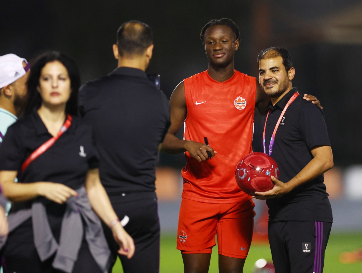 Canada’s Ismael Kone poses for a photograph with a volunteer. Reuters