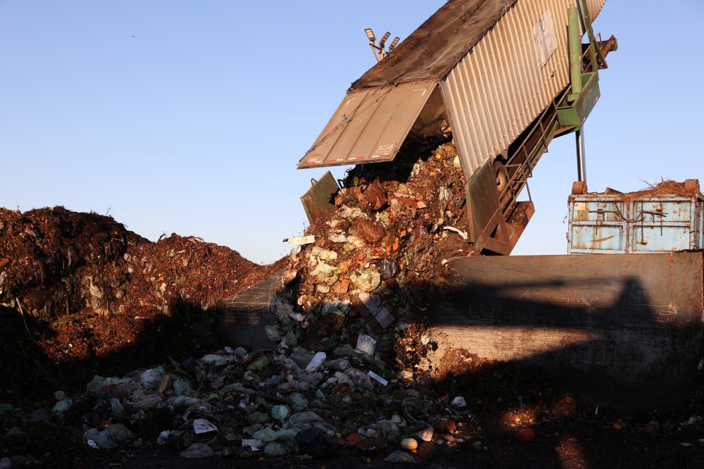 A large truck container dumps food scraps collected from the city of San Francisco into the presorting area before being processed at Recology Blossom Valley Organics North near Vernalis, California, U.S., November 10, 2022. REUTERS/Brittany Hosea-Small