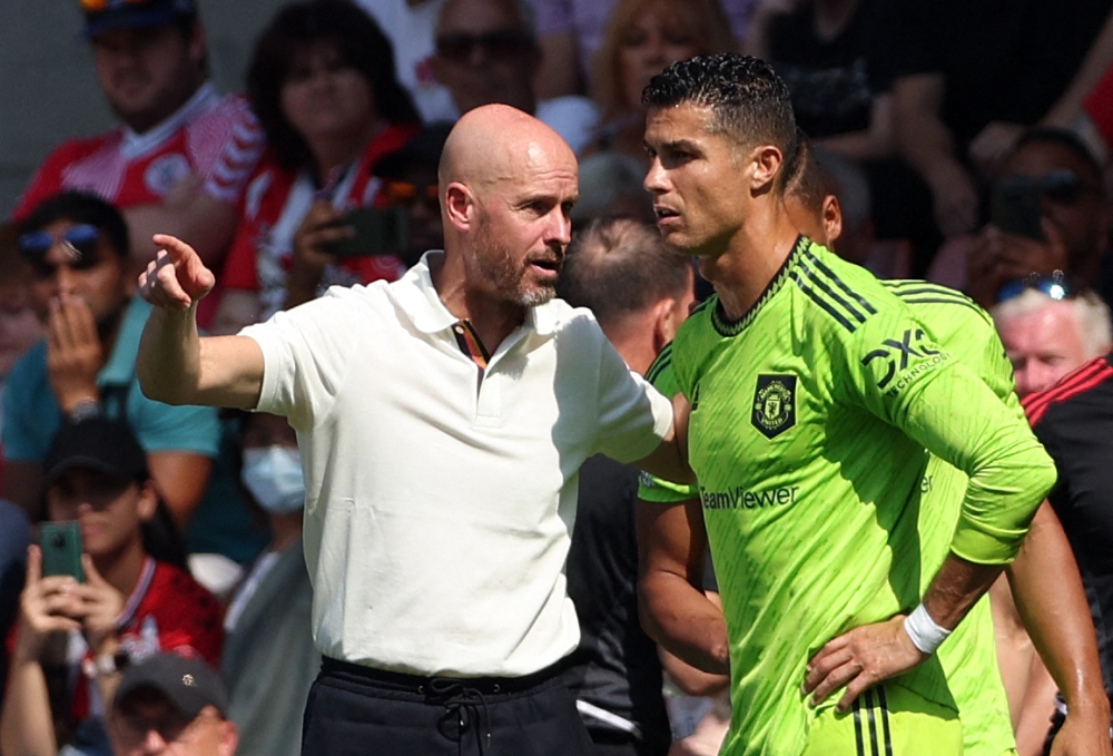 In this file photo taken on August 27, 2022 Manchester United's Dutch manager Erik ten Hag (L) directs substitute Manchester United's Portuguese striker Cristiano Ronaldo during the English Premier League football match between Southampton and Manchester United at St Mary's Stadium in Southampton, southern England. (Photo by Adrian DENNIS / AFP) 