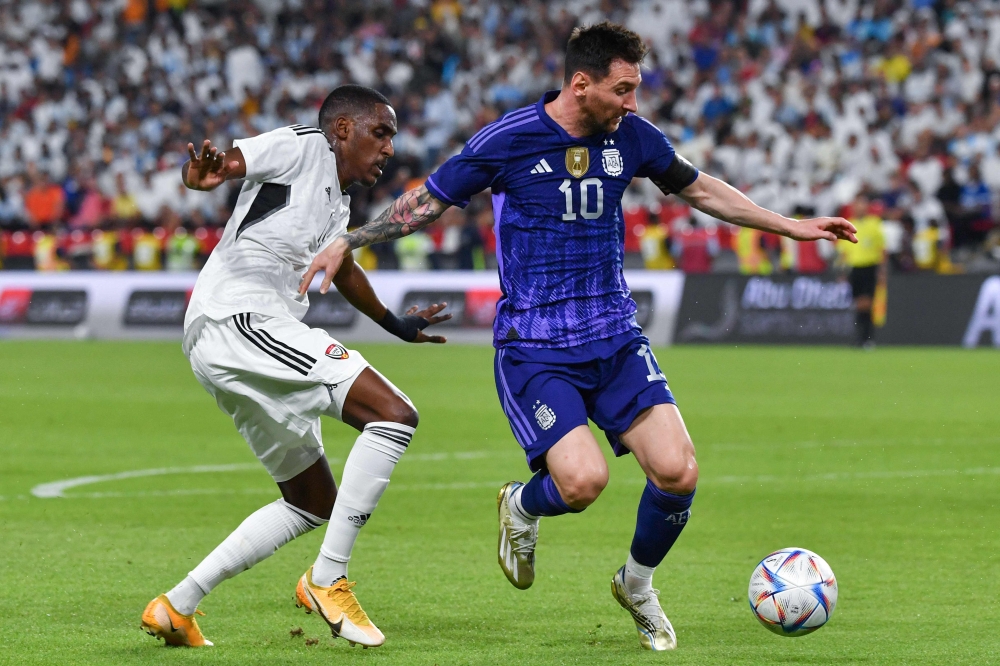 United Arab Emirates' defender Khalifa Al Hammadi (L) marks Argentina's forward Lionel Messi during the friendly football match between Argentina and the United Arab Emirates at the Mohammed Bin Zayed Stadium in Abu Dhabi, on November 16, 2022. (Photo by Ryan LIM / AFP)