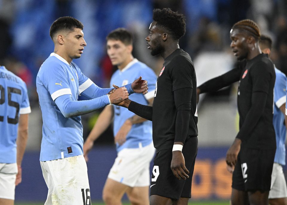 Canada's Alphonso Davies shakes hands with Uruguay's Mathias Oliveira (left) after their international friendly match at Tehelne pole, Bratislava, Slovakia, on September 27, 2022.  File Photo / Reuters
