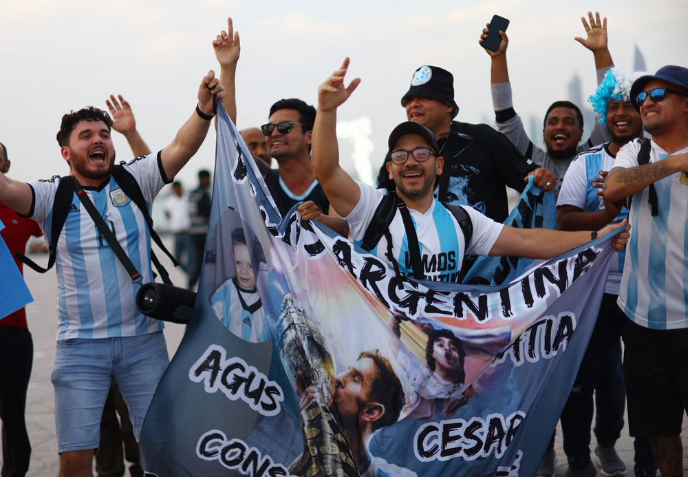 Fans celebrate the arrival of the Argentina team. REUTERS