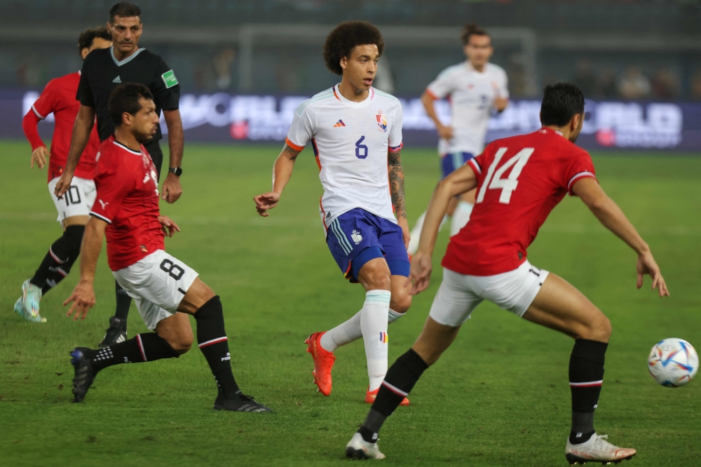 Egypt's players mark Belgium's midfielder Axel Witsel (C) during the friendly football match between Belgium and Egypt at the Jaber Al-Ahmad Stadium in Kuwait City on November 18, 2022. (Photo by Yasser Al-Zayyat / AFP