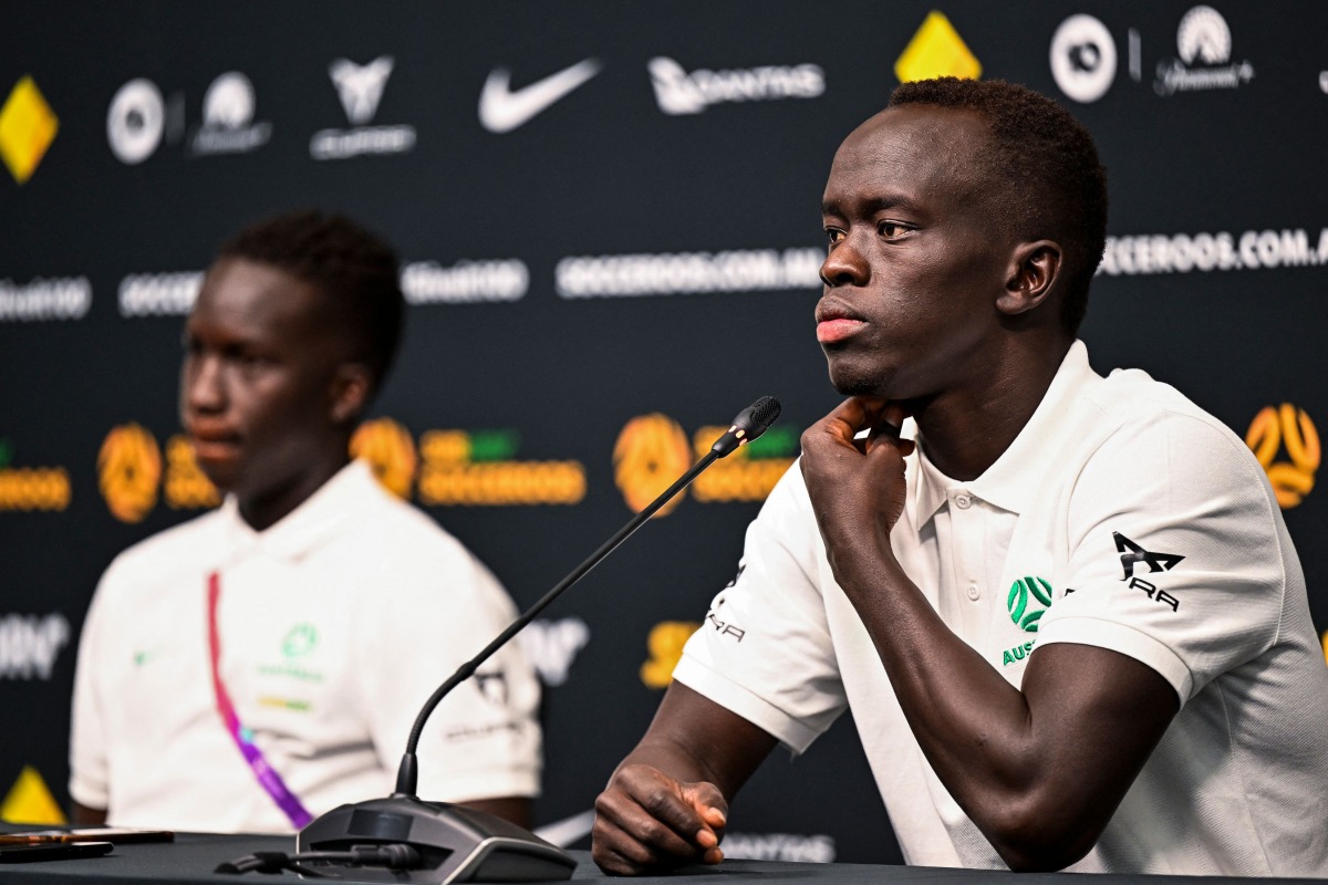 Awer Mabil (right) addresses a press conference at the Aspire Academy in Doha, yesterday. AFP