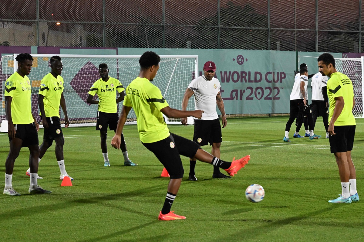 Senegal legend El Hadji Diouf with players during a training session in Doha, yesterday. AFP