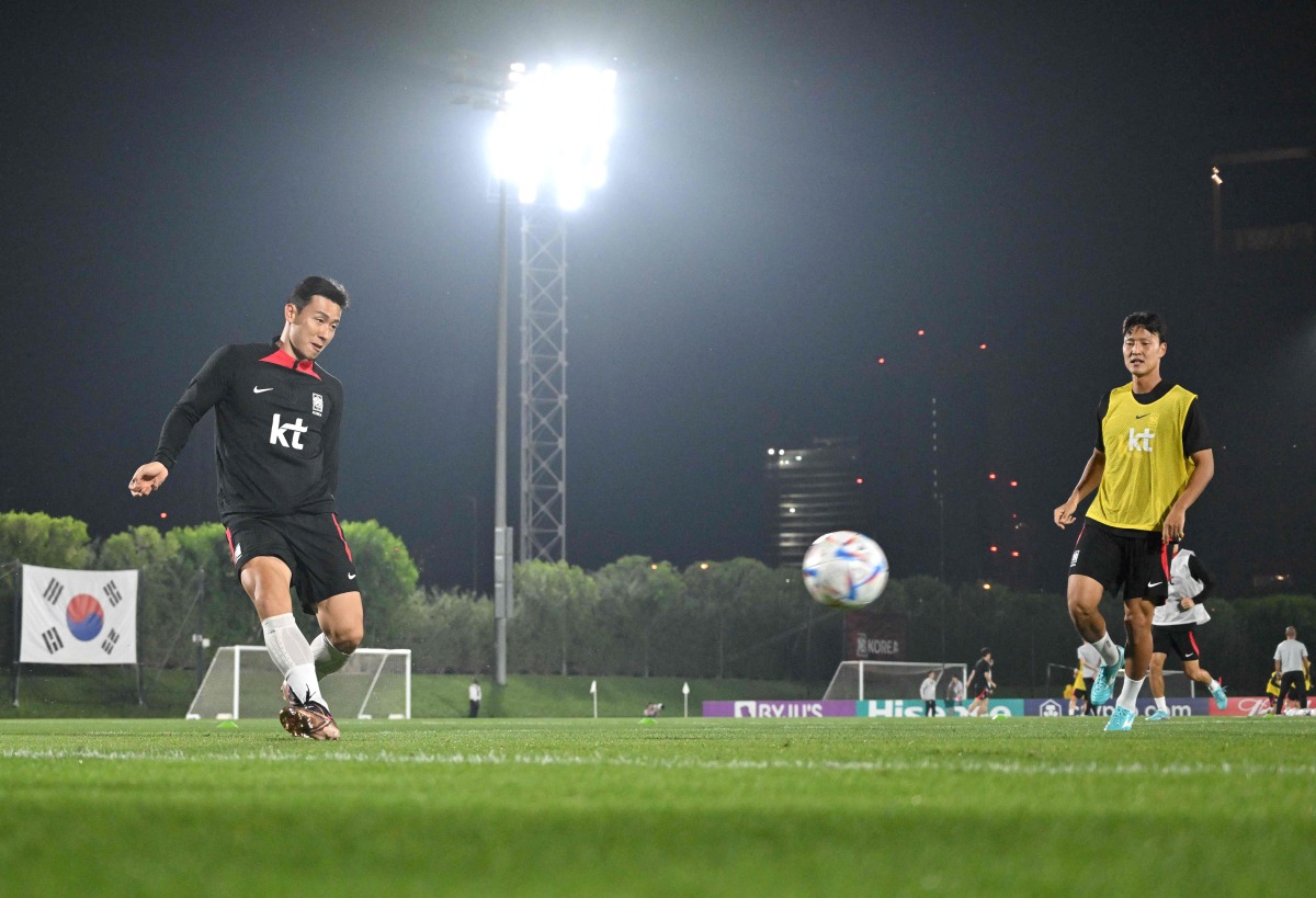 South Korea’s defender Kim Tae-hwan (left) takes part in a training session at Al Egla Training Site 5, yesterday. AFP