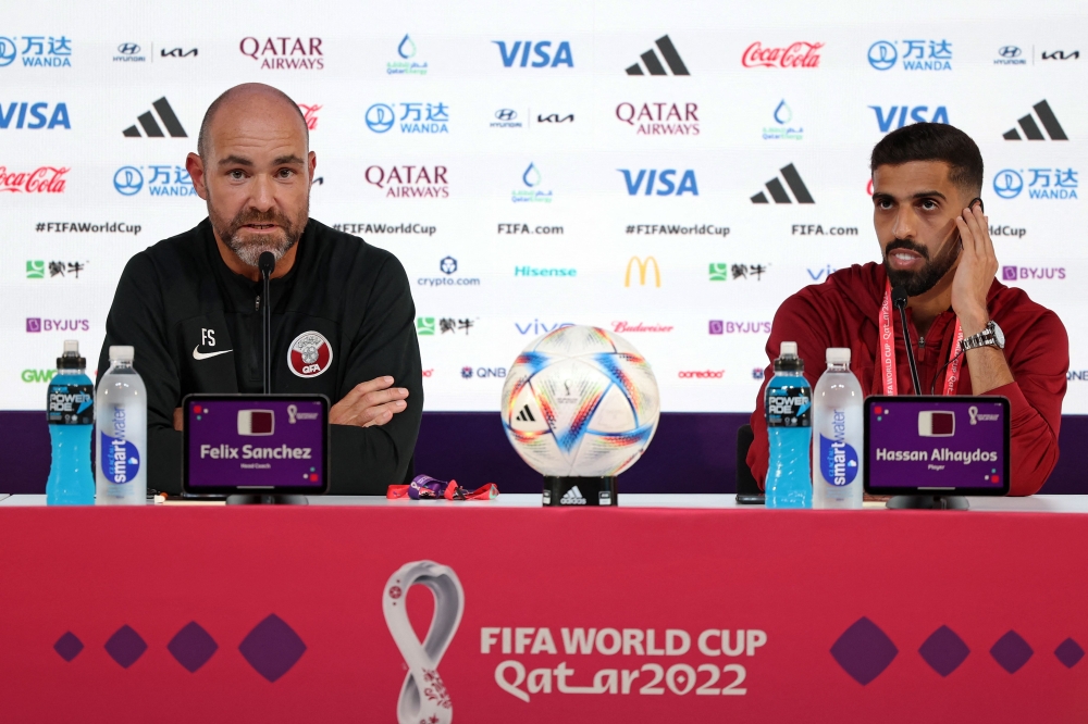 Qatar's Spanish coach Felix Sanchez (L) and Qatar's forward Hassan Al-Haydos attend a press conference at the Qatar National Convention Center (QNCC) in Doha. (Photo by Karim Jaafar / AFP)