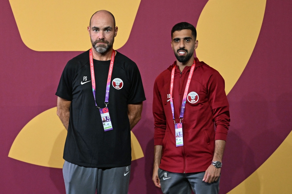 Qatar's Spanish coach Felix Sanchez (left) and Qatar's forward Hassan Al-Haydos arrive for a press conference at the Aspire training site in Doha on November 19, 2022 on the eve of the Qatar 2022 World Cup football opening match between Qatar and Ecuador. (Photo by Raul ARBOLEDA / AFP)