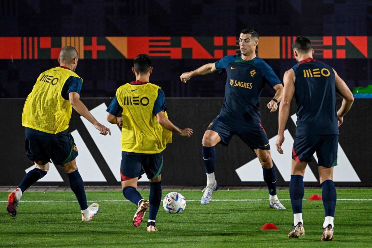 Portugal’s forward Cristiano Ronaldo (second right) takes part in a training session alongside teammates at Shahaniya Sports Club in Al Samriya, yesterday. AFP