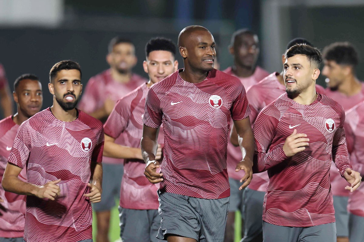 From left: Qatar’s Hassan Al Haydos, Abdelkarim Hassan and Bassam Al Rawi take part in a training session at the Aspire training site, yesterday. Pictures: AFP