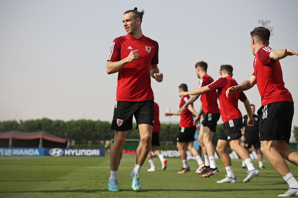 Wales’ forward Gareth Bale warms up with his team mates during a training session at the Al Saad SC in Doha. AFP