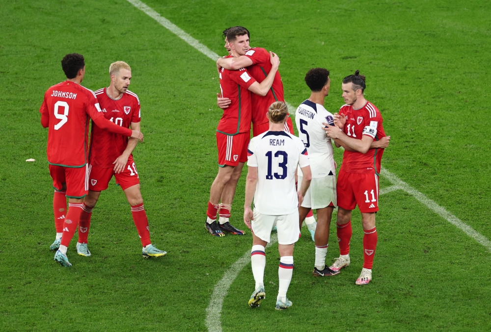 Wales' Gareth Bale, Aaron Ramsey and Brennan Johnson with Antonee Robinson and Tim Ream of the US after the FIFA World Cup Qatar 2022 Group B match between United States and Wales at Ahmad Bin Ali Stadium, Qatar, November 22, 2022. (REUTERS/Marko Djurica)