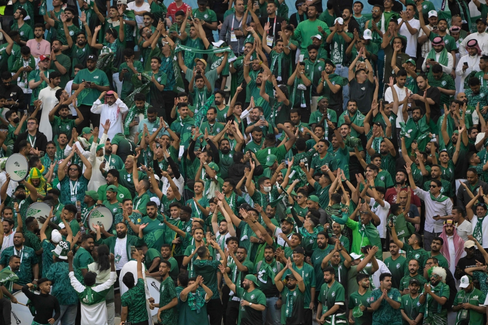 Saudi Arabia supporters celebrate their victory in the Qatar 2022 World Cup Group C football match between Argentina and Saudi Arabia at the Lusail Stadium in Lusail, north of Doha on November 22, 2022. (Photo by JUAN MABROMATA / AFP)