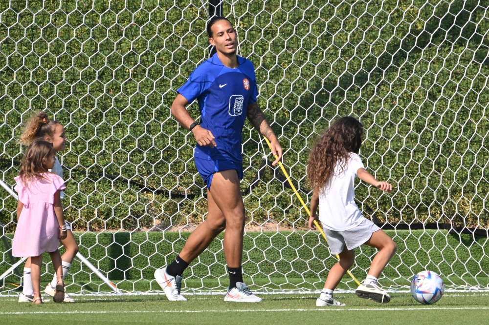 Netherlands' defender Virgil van Dijk plays with his children during a meeting with relatives after a training session at Qatar University training ground in Doha on November 22, 2022 during the Qatar 2022 World Cup football tournament. (Photo by Alberto PIZZOLI / AFP)