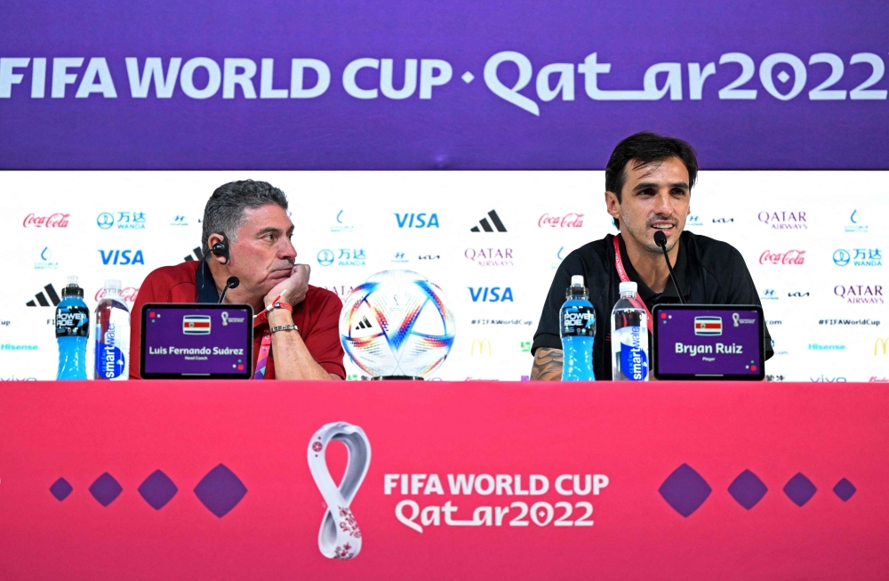 Costa Rica's Colombian coach Luis Suarez (L) and midfielder Bryan Ruiz give a press conference at the Qatar National Convention Centre (QNCC) in Doha on November 22, 2022, during the Qatar 2022 World Cup football tournament. (Photo by Raul ARBOLEDA / AFP)