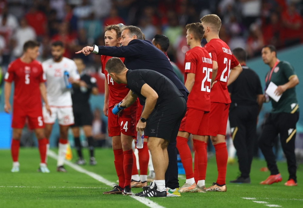 Denmark coach Kasper Hjulmand with Mikkel Damsgaard before he comes on as a substitute during the Qatar 2022 World Cup Group D football match between Denmark and Tunisia at the Education City Stadium in Al-Rayyan, west of Doha on November 22, 2022. (REUTERS/Kai Pfaffenbach)