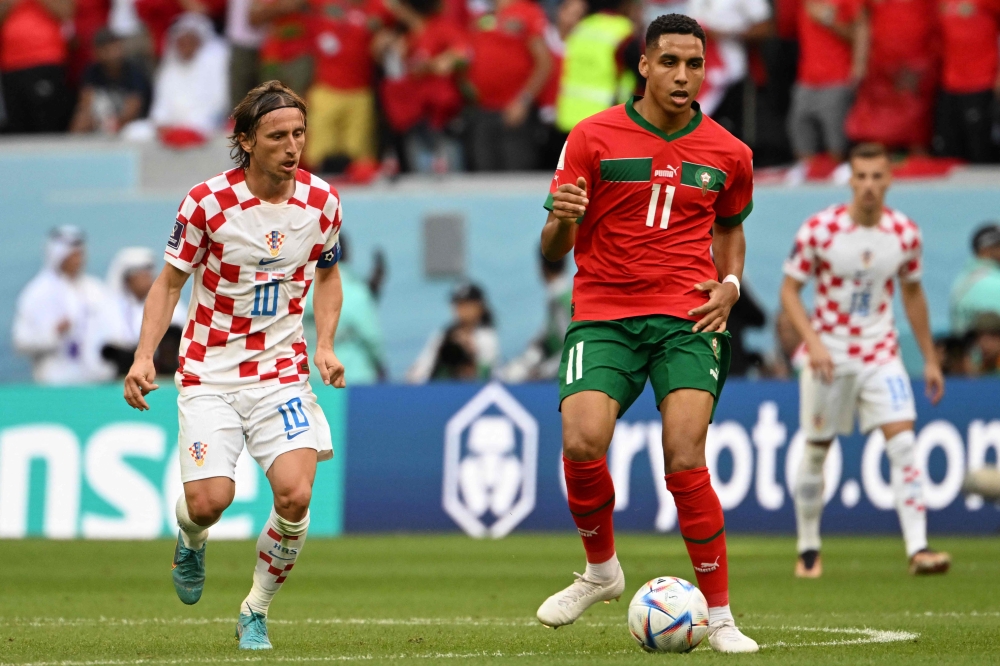 Croatia's midfielder #10 Luka Modric follows Morocco's midfielder #11 Abdelhamid Sabiri during the Qatar 2022 World Cup Group F football match between Morocco and Croatia at the Al-Bayt Stadium in Al Khor, north of Doha on November 23, 2022. (Photo by OZAN KOSE / AFP)
 