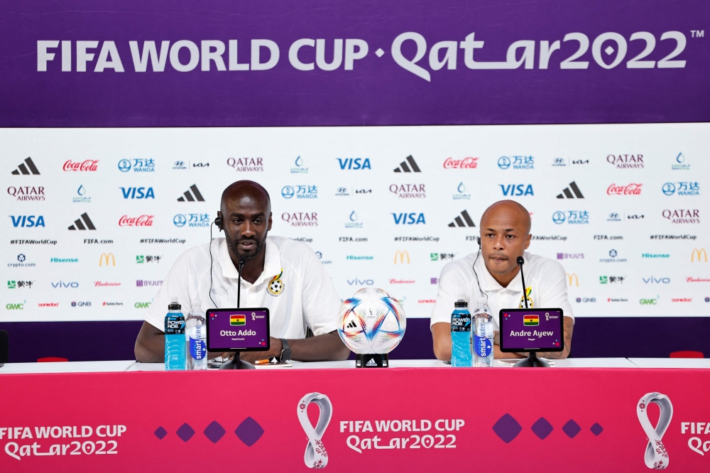 Ghana's coach Otto Addo (left) and player Andre Ayew attend a press conference at the Qatar National Convention Center (QNCC) in Doha, on November 23, 2022, on the eve of the Qatar 2022 World Cup football match between Portugal and Ghana. (Photo by Khaled DESOUKI / AFP)