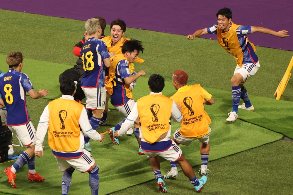 Japan's Takuma Asano celebrates scoring their second goal with teammates. (REUTERS/Molly Darlington)