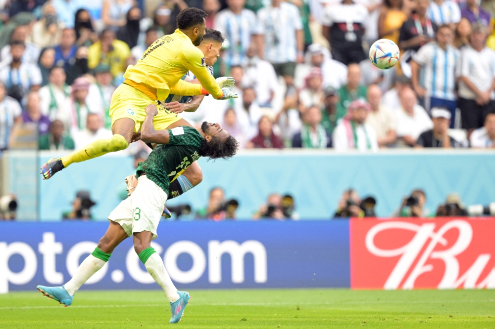 Saudi Arabia's goalkeeper Mohammed Al-Owais hits Saudi Arabia's defender Yasser Al-Shahrani in the head during the Qatar 2022 World Cup Group C football match between Argentina and Saudi Arabia at the Lusail Stadium in Lusail, north of Doha, on November 22, 2022. (AFP/Juan Mabromata)