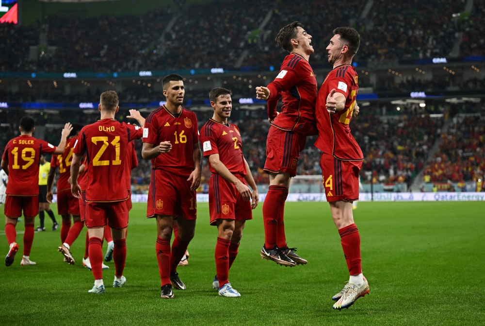 Spain's Gavi celebrates scoring their fifth goal with Aymeric Laporte. (REUTERS/Dylan Martinez)